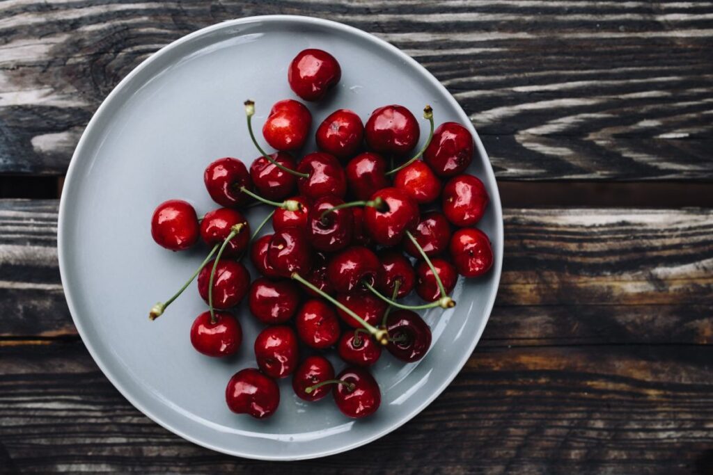 Fresh Cherries on a simple plate Stock Free