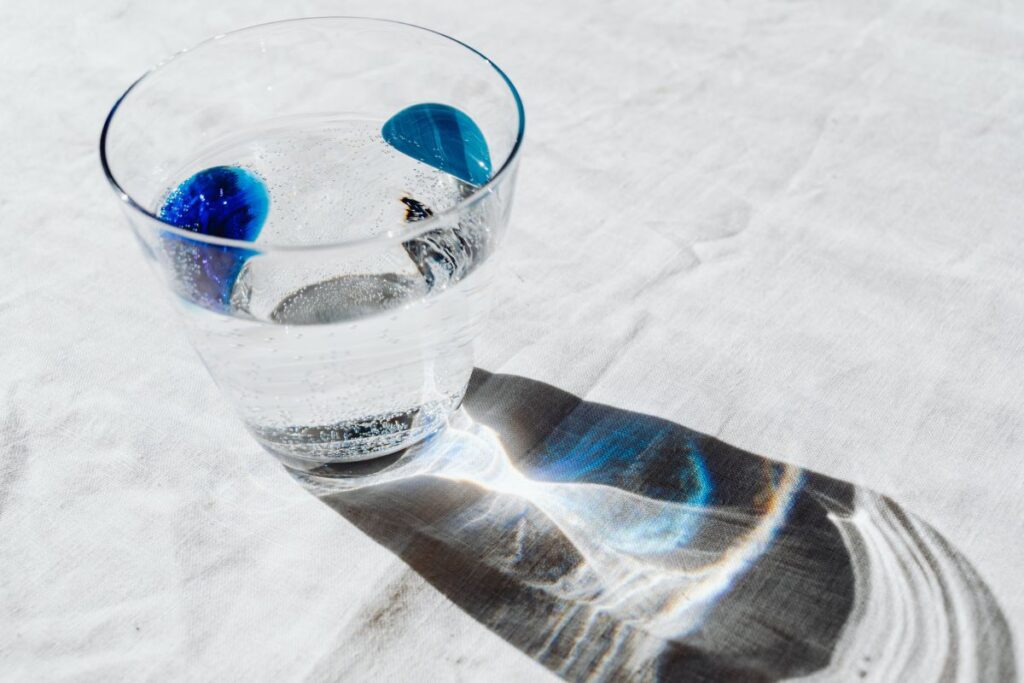 Glass of water on the linen tablecloth Stock Free