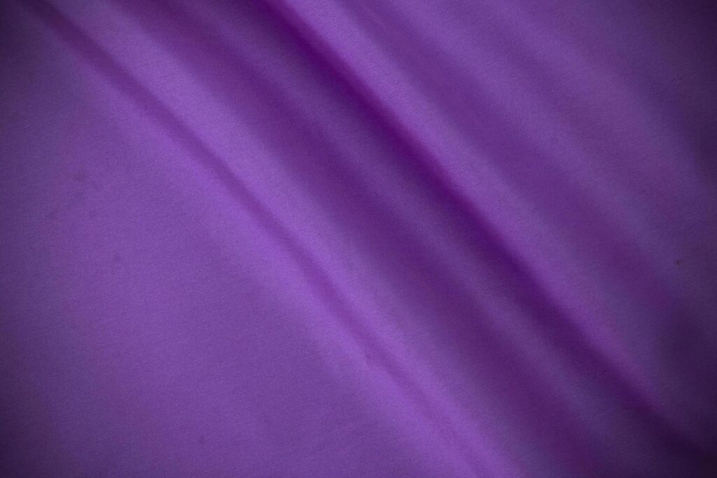 2 smooth purple cotton Texture, curved silk background, pattern. Texture of purple silk fabric. Beautiful emerald soft silk. Stock Free