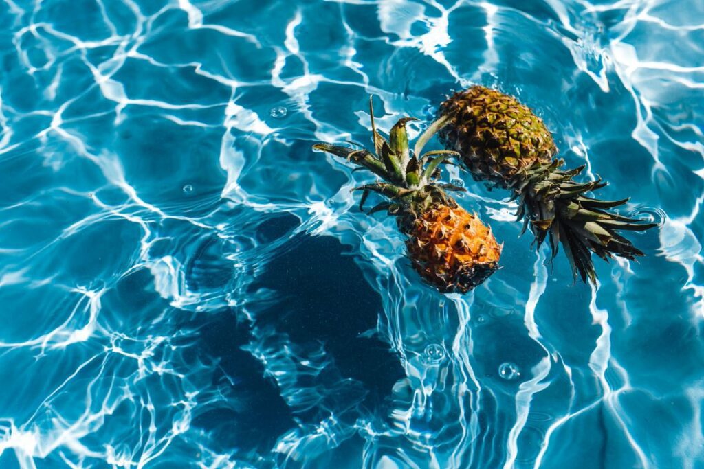 Pineapple in a swimming pool Stock Free