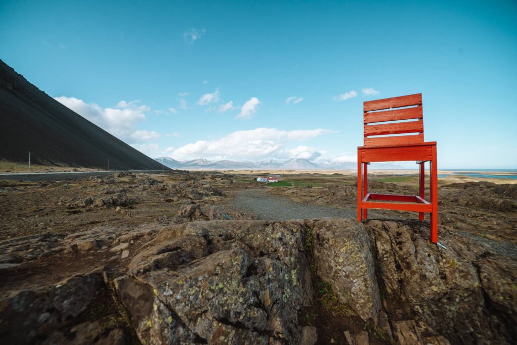 A Giant Red Chair Bolted to a Rock in Iceland Free Photo