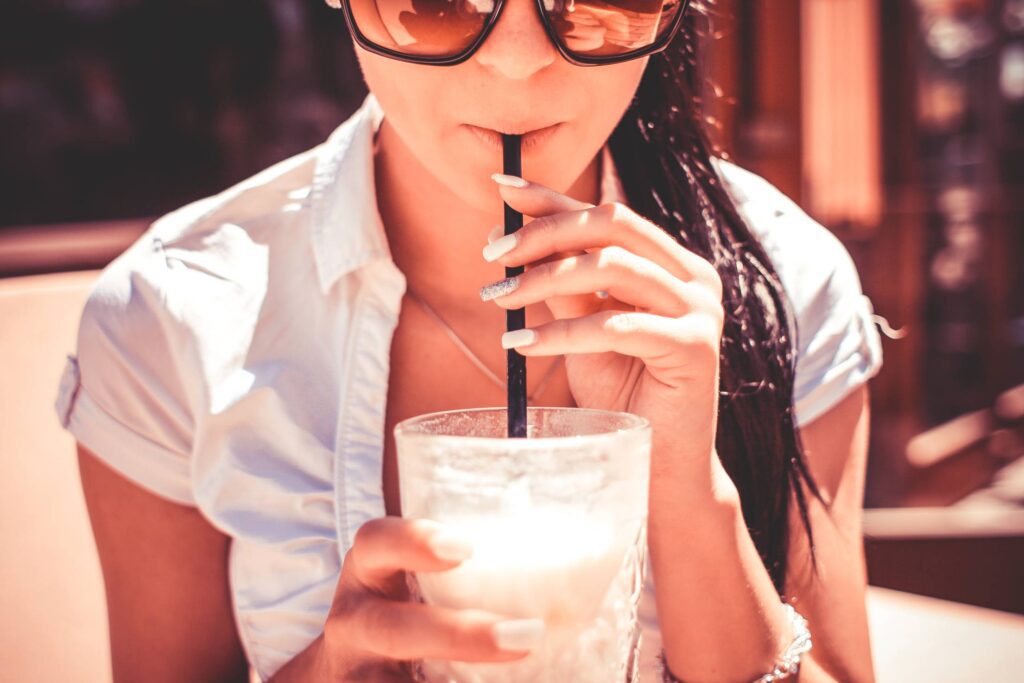 A Girl Drinking Milkshake Drink in Caffe Free Photo