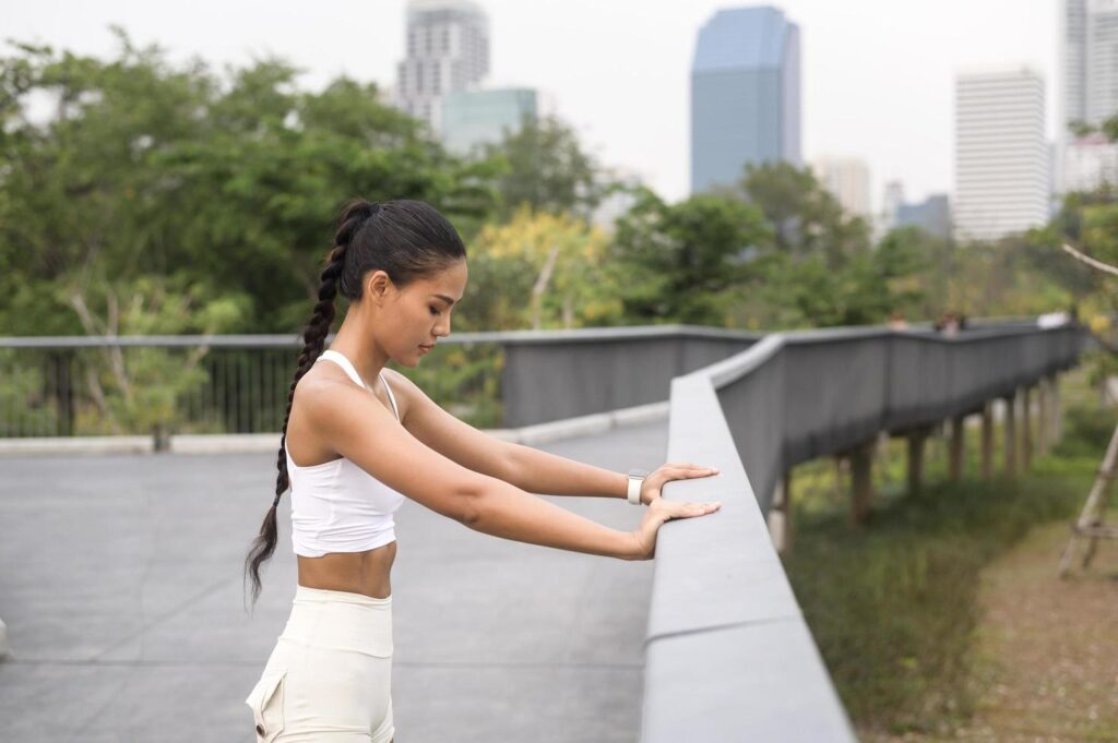 A young fitness woman in sportswear exercising in city park, Healthy and Lifestyles. Stock Free