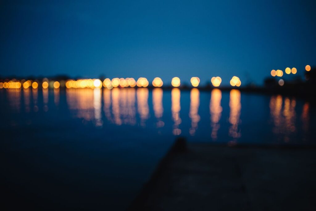 City lights reflected in the water at night Stock Free