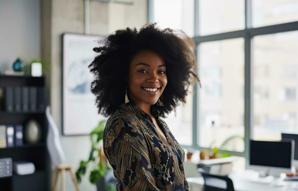 AI generated an afroamerican business woman standing in an office with a smile on her face Stock Free