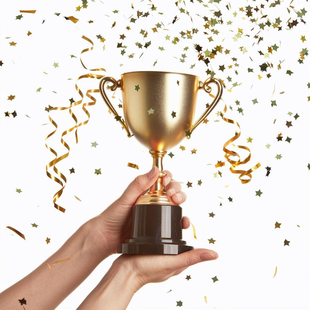 hands of business woman holding and lift a golden trophy, surrounding with congratulations confetti ribbon flakes. Free Photo