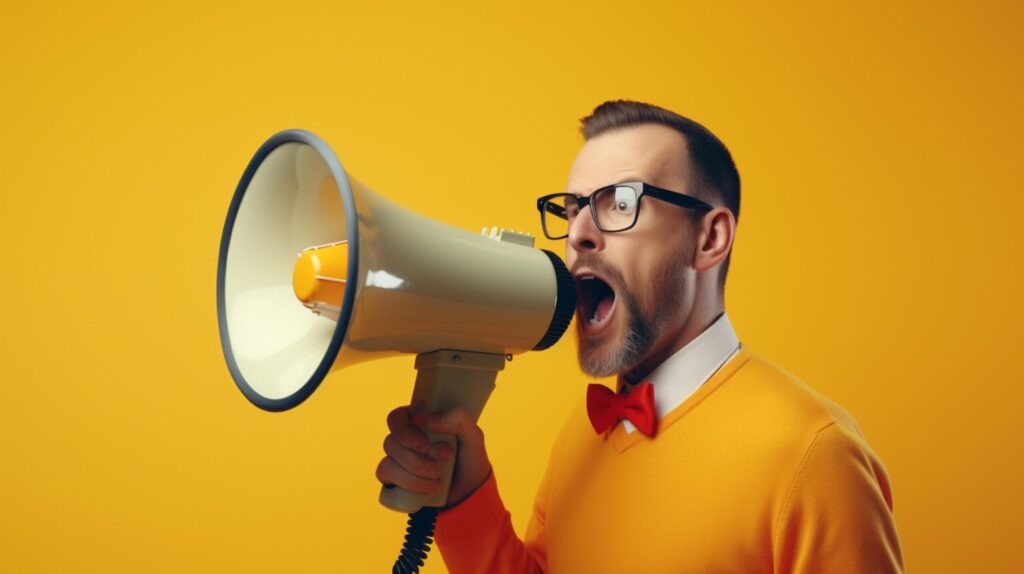 man holding megaphone standing on Mustard background Free Photo