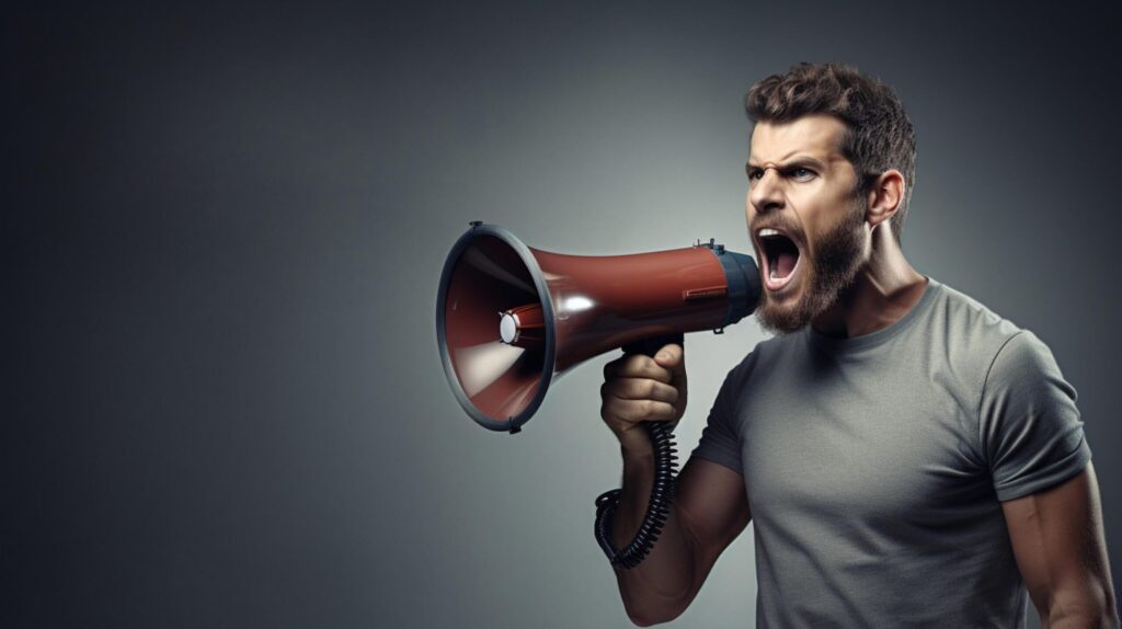 man holding megaphone standing on Silver background Free Photo