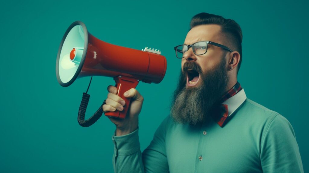 man holding megaphone standing on Teal background Free Photo