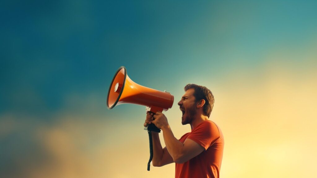 man holding megaphone standing on Topaz background Free Photo