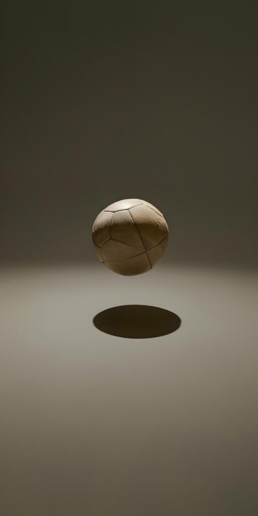 Midair Soccer Ball in Dramatic Lighting Free Photo