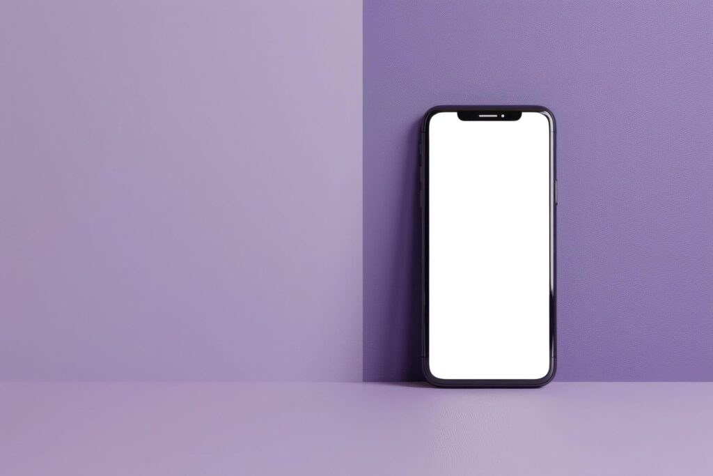 Smartphone with a blank screen standing against a textured purple wall, showcasing a modern look for presentation Free Photo