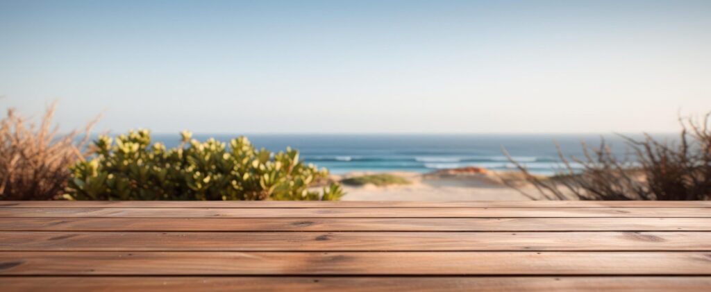 wooden table with a blurry ocean view Free Photo