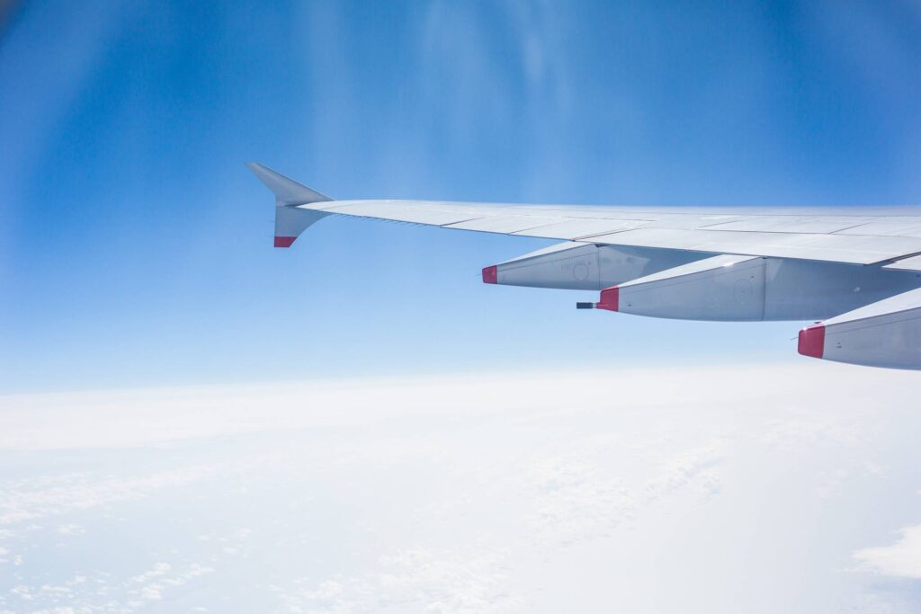 Airplane Wing and Cloudy Sky Free Photo