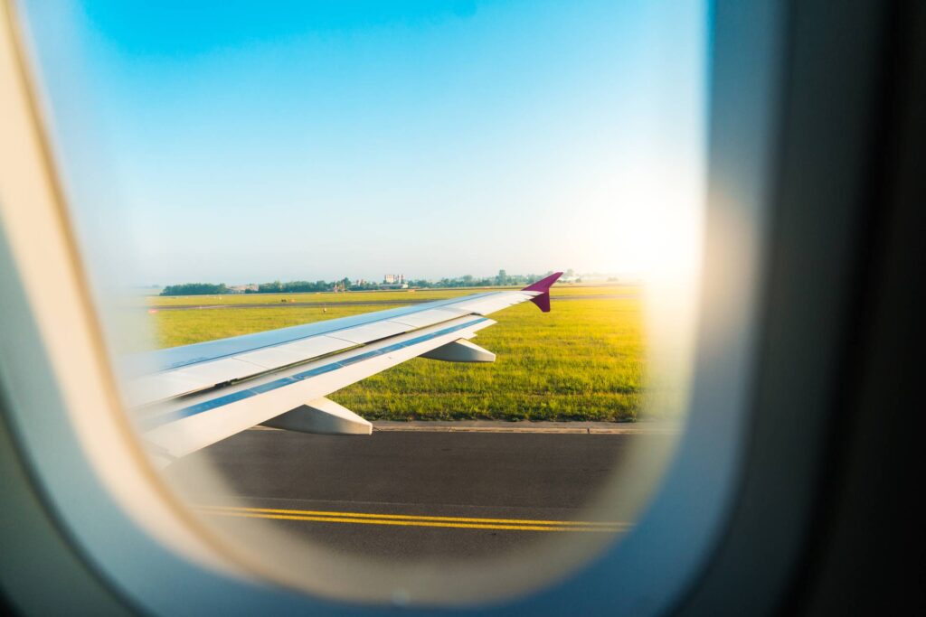 Airplane Wing Through Window During Take Off Free Photo