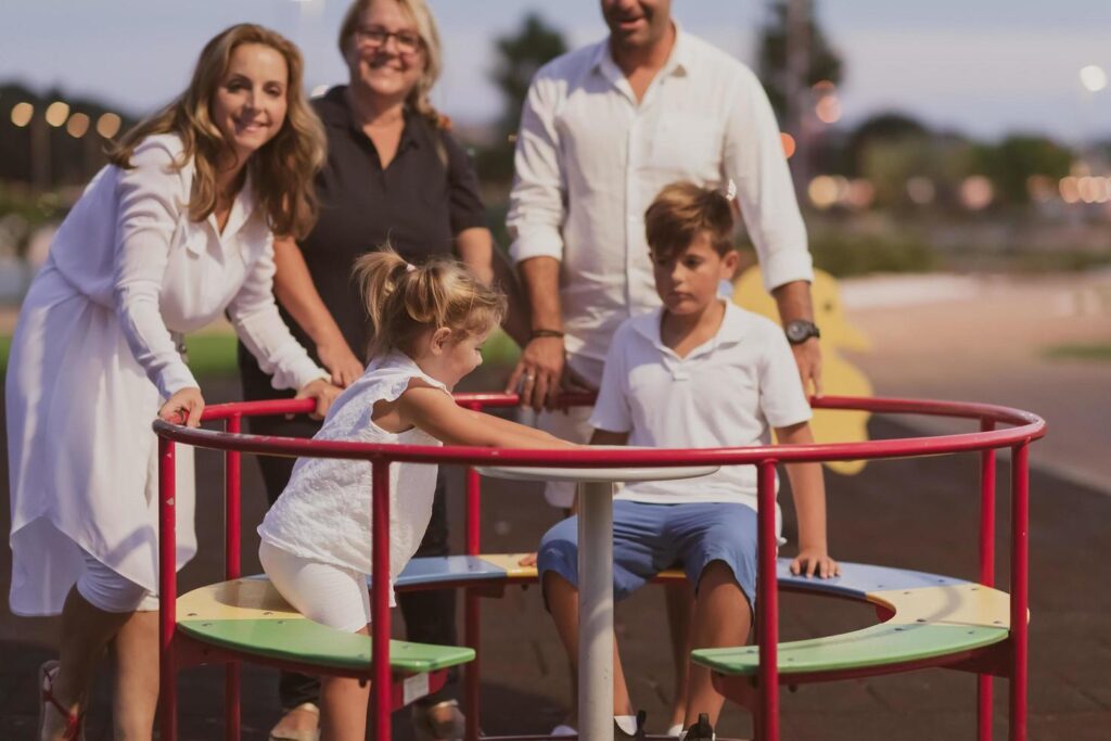 An elderly couple in casual clothes with their children and grandmother spend time together in the park on vacation. Family time. Selective focus Stock Free