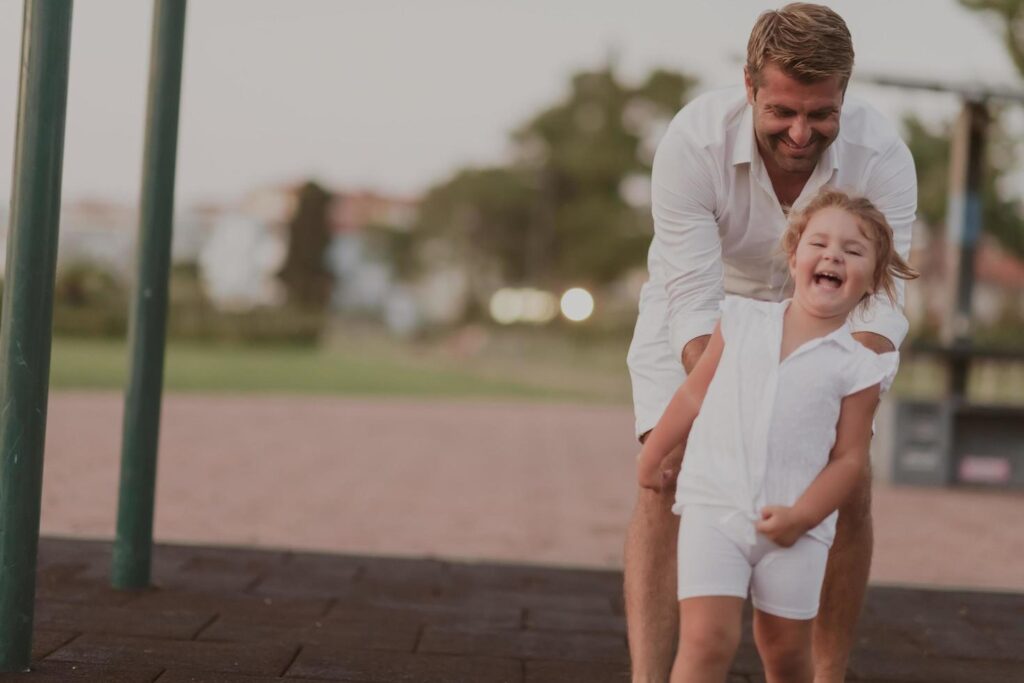 An elderly man in casual clothes with his daughter spends time together in the park on vacation. Family time. Selective focus Stock Free