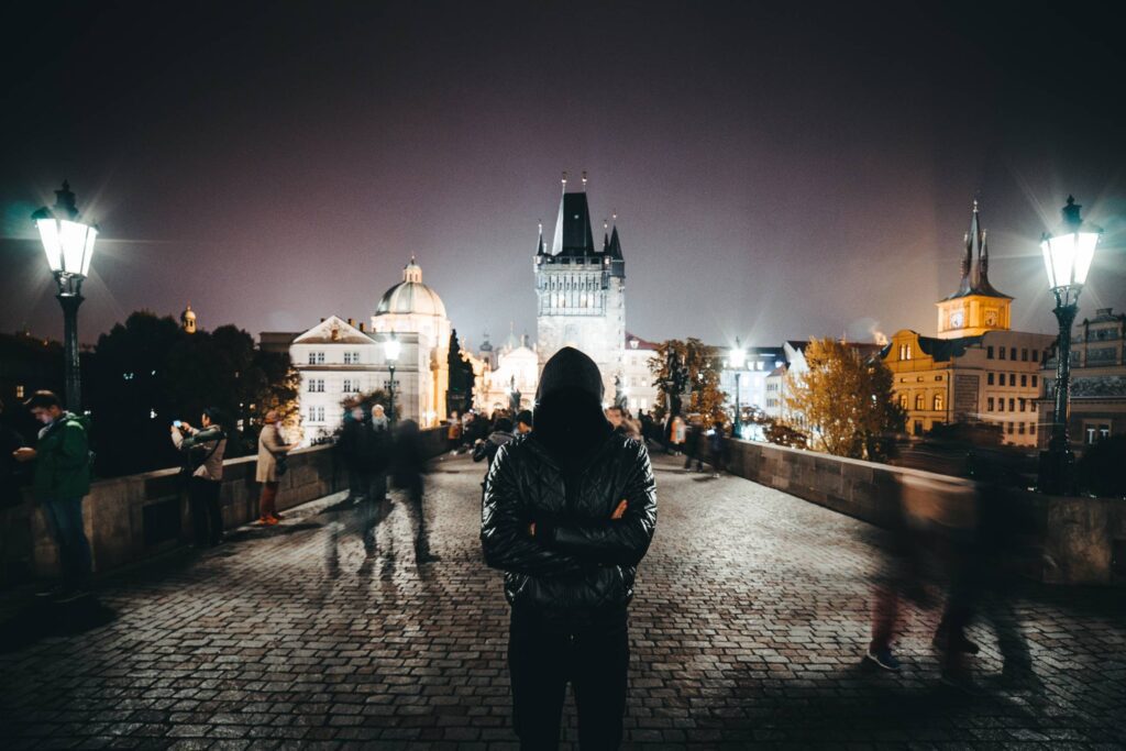 Anonymous Man with Crossed Arms Standing on Charles Bridge Free Photo