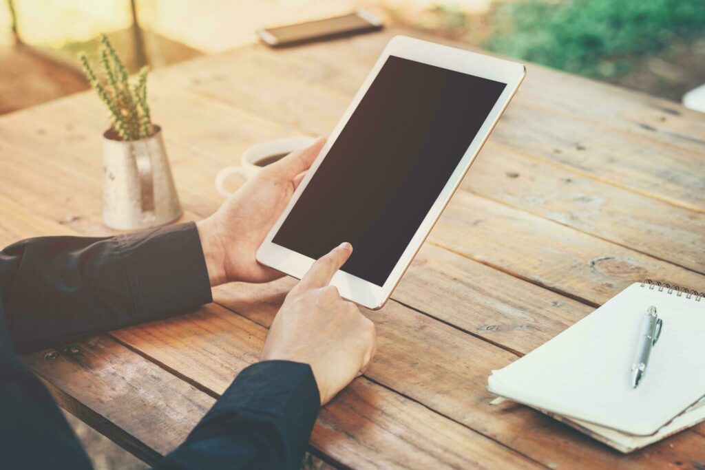 Asia business man using tablet on table in coffee shop with vintage toned filter. Stock Free