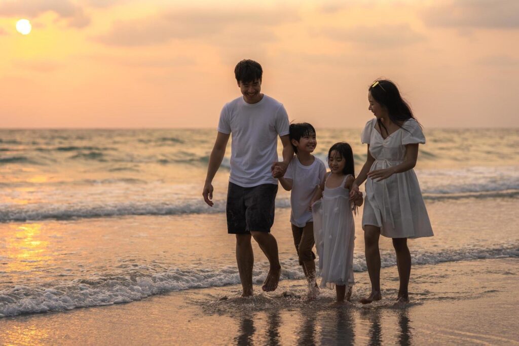 Asian family enjoy vacation on beach Stock Free