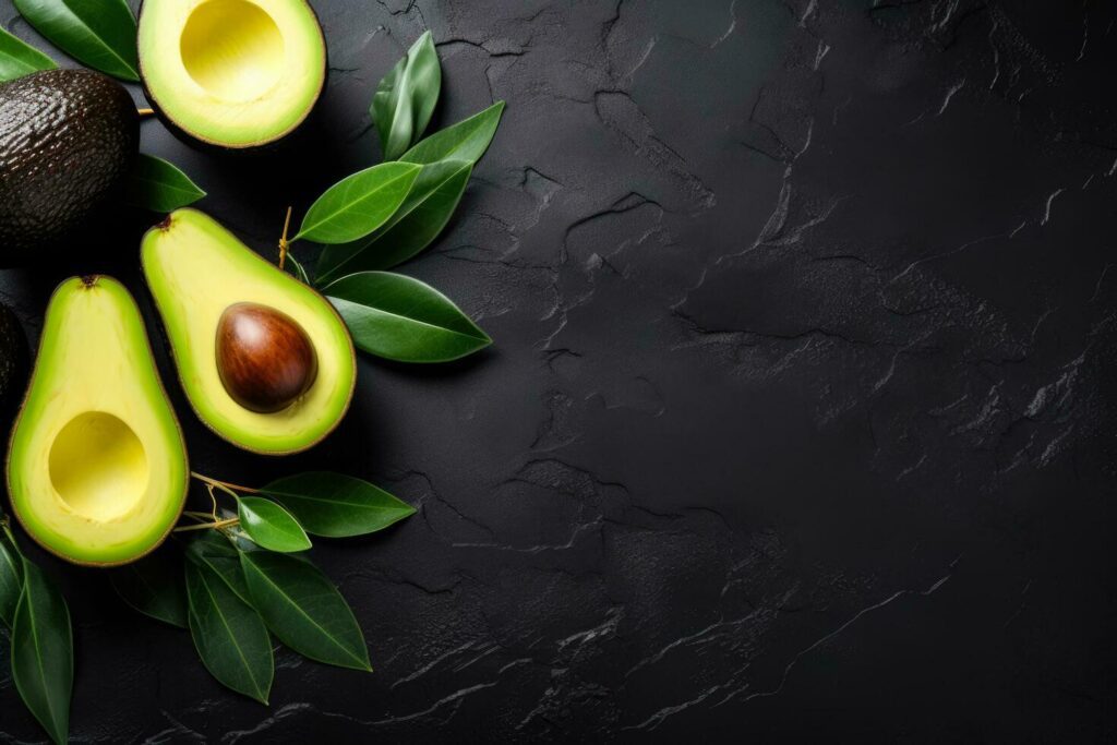 Avocado halves on grey vegan food top view with copy space Stock Free