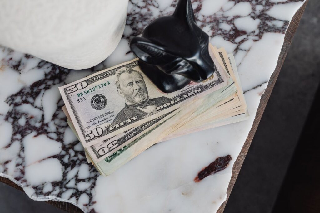 Dollar bills on a marble table Stock Free