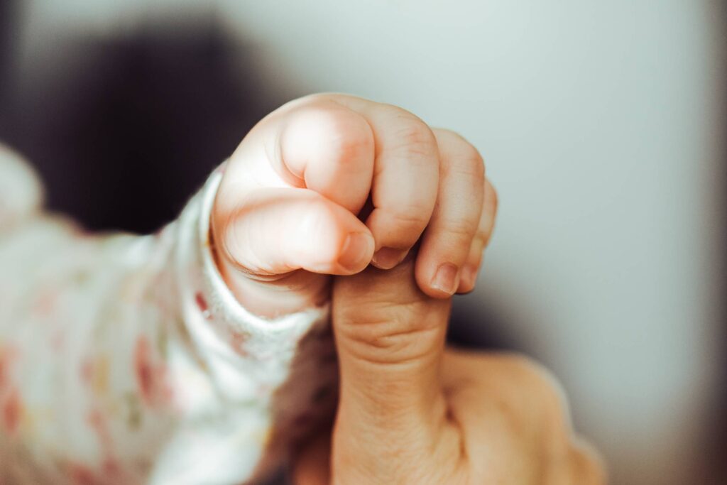 Baby Hand Holding Adult Finger Free Photo