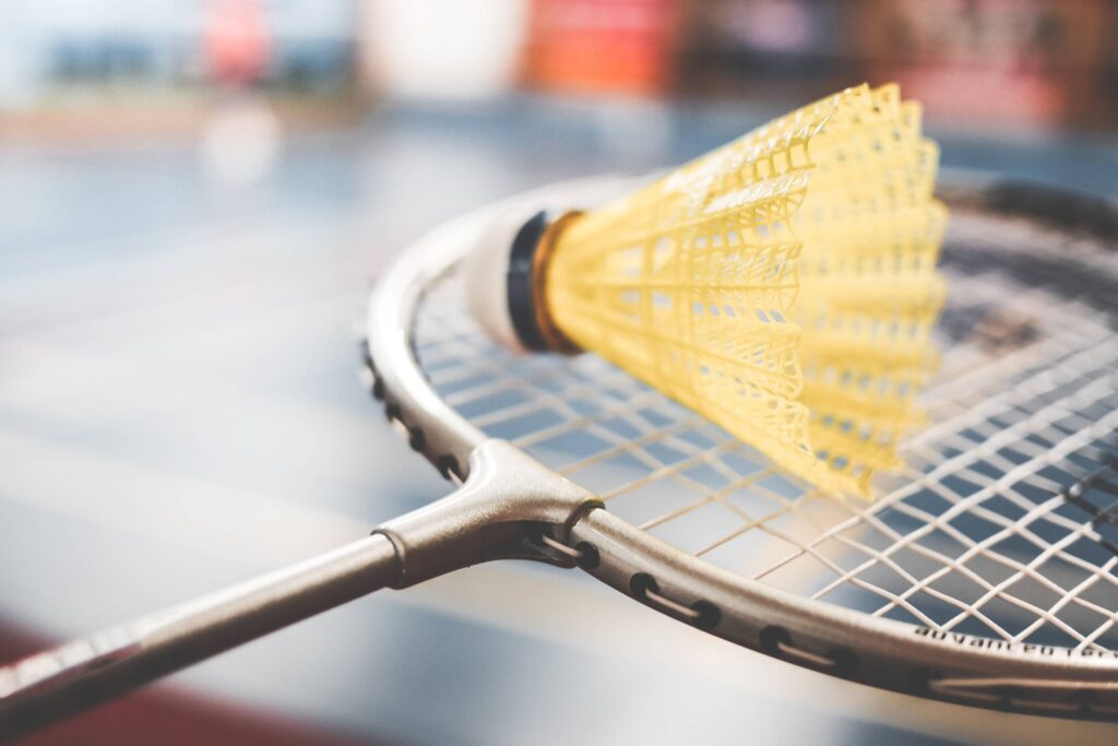 Badminton Racket and Yellow Shuttlecock Close Up Free Photo