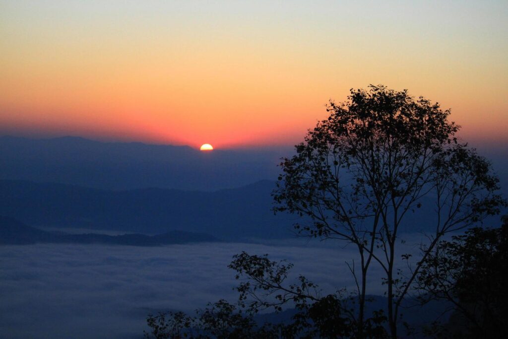 
									Beautiful golden natural sunlight and twiligh of sunrise shining to in the mist on valley of mountain in Thailand Stock Free