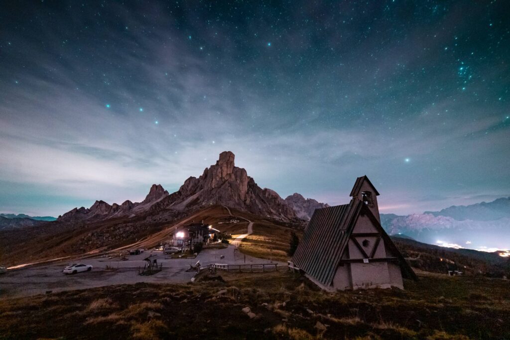 Beautiful View of a Church and a Rock Under a Night Sky Free Photo