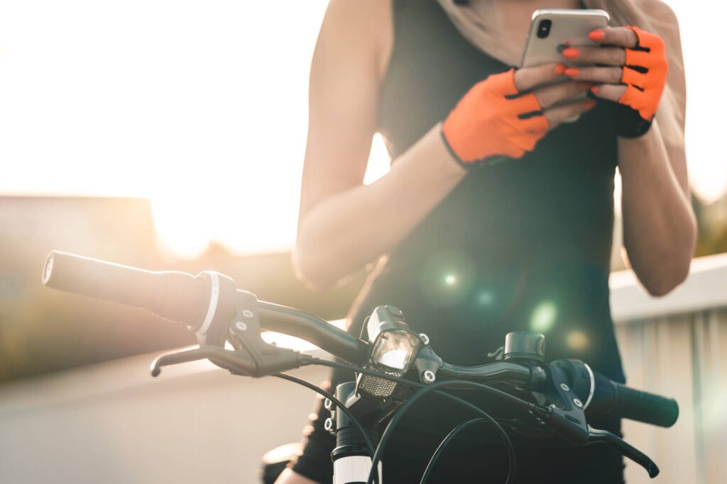 Bicycle Woman Planning a Cycling Route on Her Smartphone Free Photo