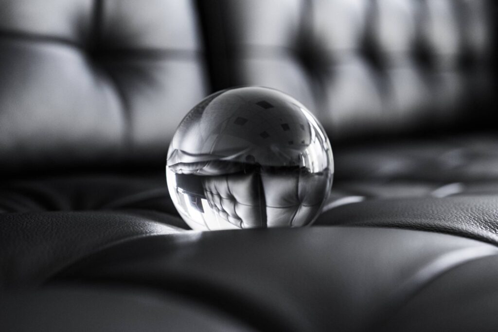 Big Glass Crystal Ball on Black Leather Sofa Free Photo