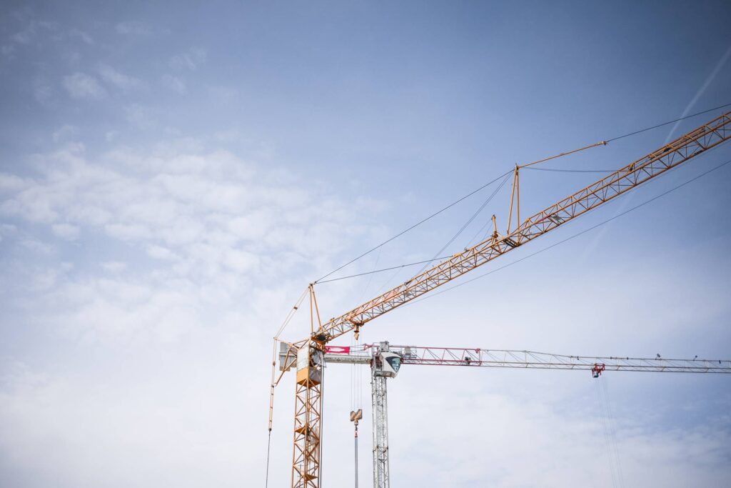 Big Lifting Cranes at Construction Site Free Photo