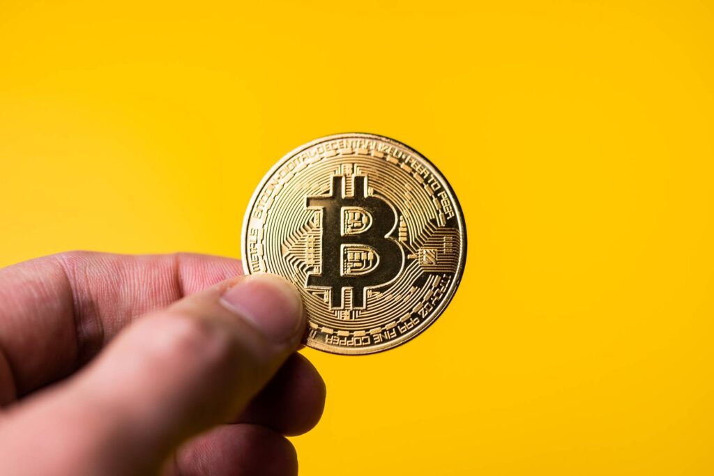 Bitcoin Golden Coin on Yellow Background Free Photo