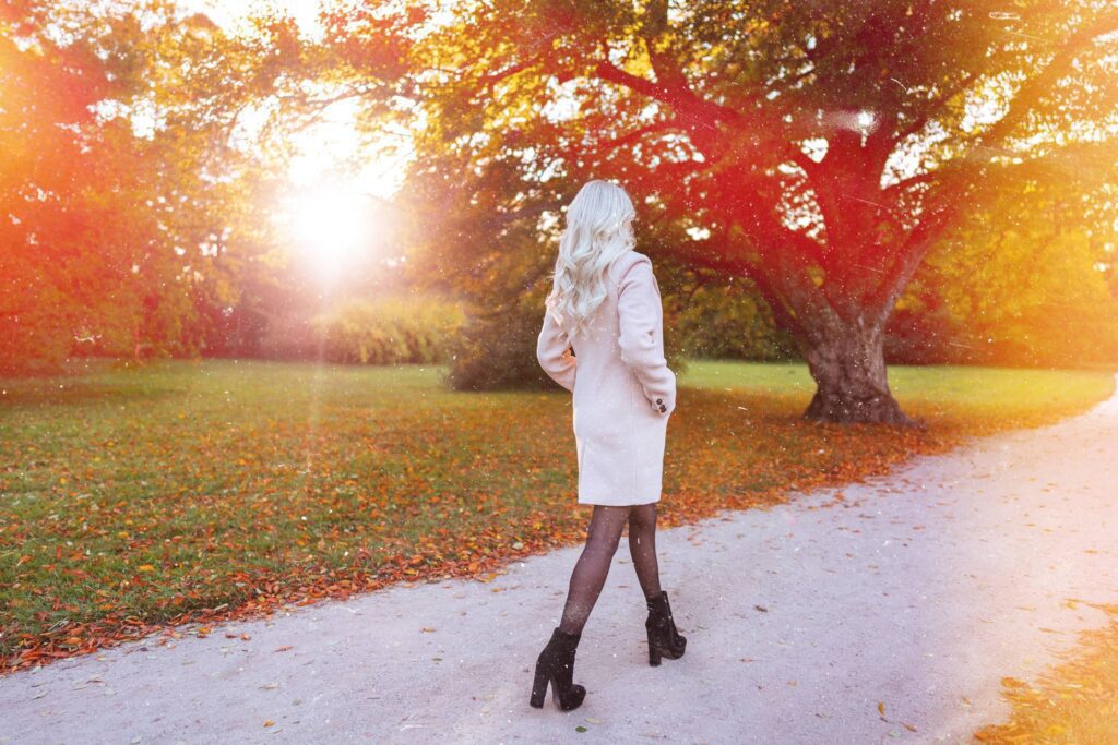 Blonde Woman in a Coat Walking in the Autumn Park Free Photo