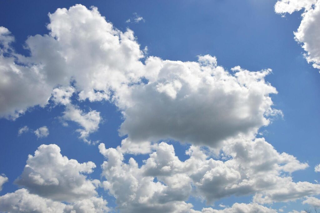 
									Blue sky with beautiful voluminous white clouds. Natural background. Stock Free