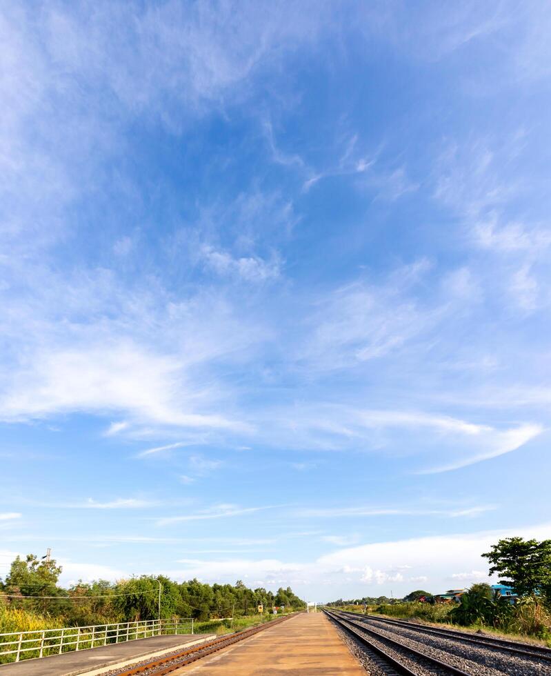 Blue sky with clouds, Sky background image, Platforms and railway tracks at bottom of picture. Stock Free