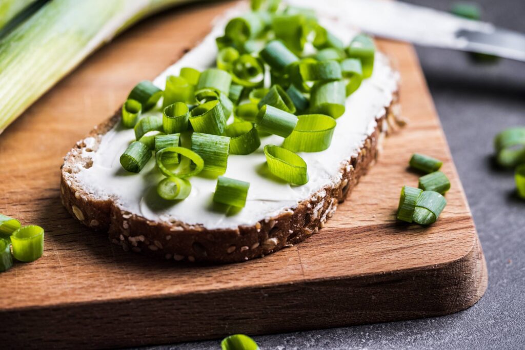 Bread with Spring Onion on a Chopping Board Free Photo