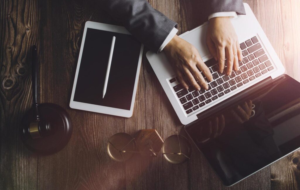 Business and lawyers discussing contract papers with brass scale on desk in office. Law, legal services, advice, justice and law concept picture with film grain effect Stock Free