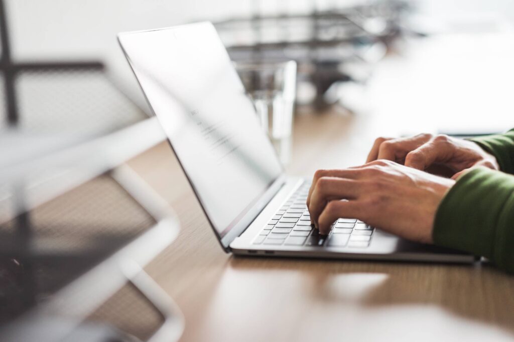 Business Copywriter Typing on His Modern Laptop Free Photo