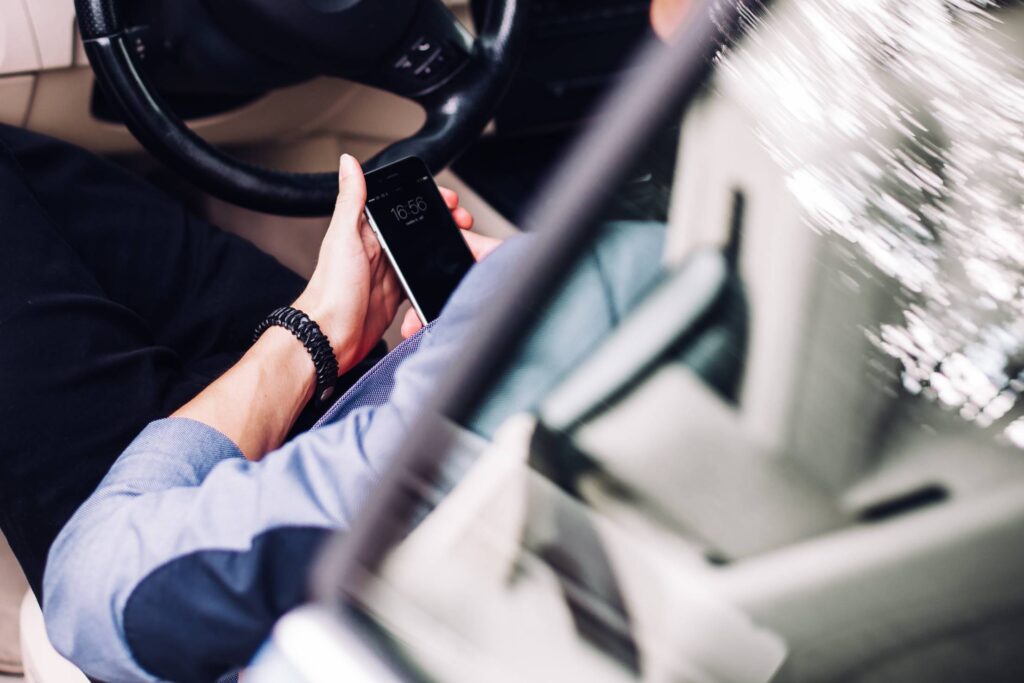 Business Manager Using His Phone in a Car Free Photo