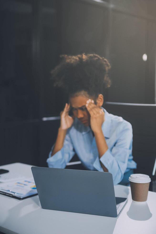 business woman sitting at work stressed , out working hard Feeling stressed out and dizzy from your job Stock Free