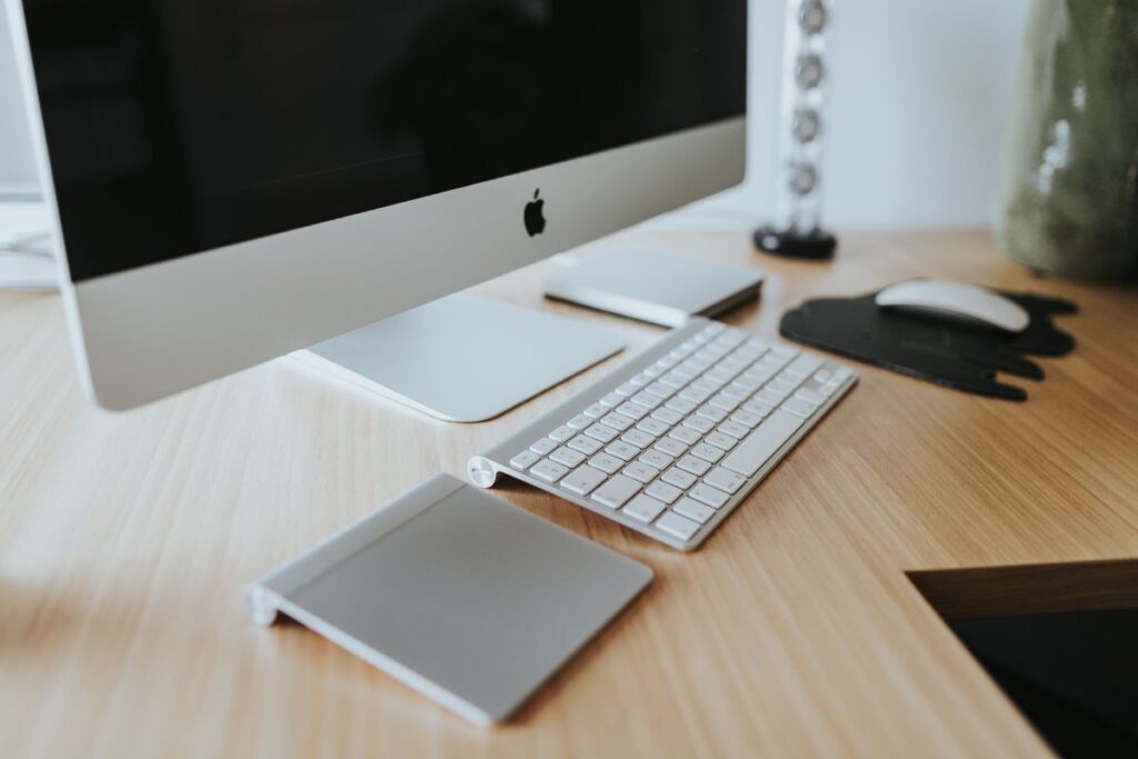 White Apple iMac computer with elephant mousepad Stock Free