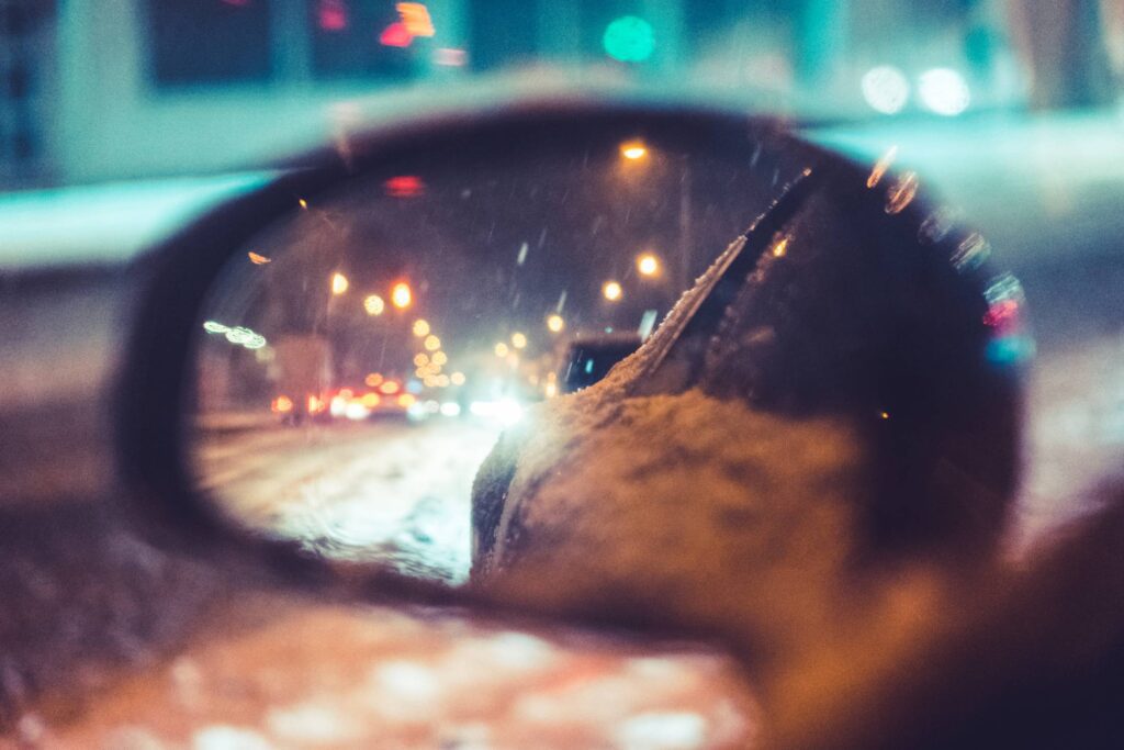 Car Side Rear-View Mirror in Snowy Night Free Photo