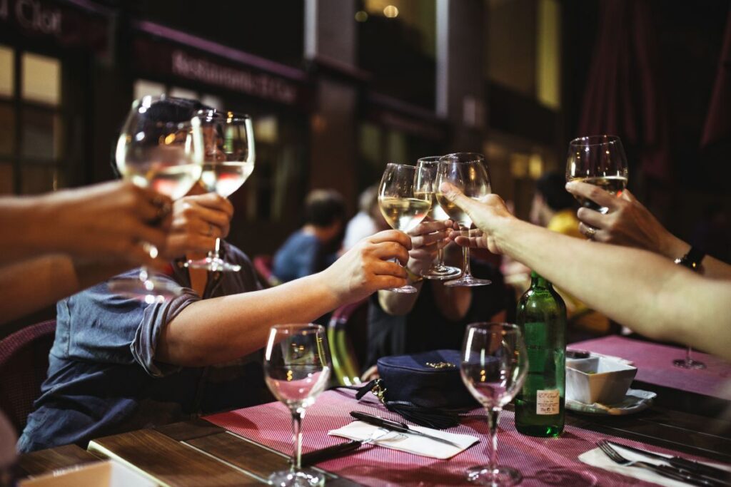 Friends at a restaurant drinking wine Stock Free