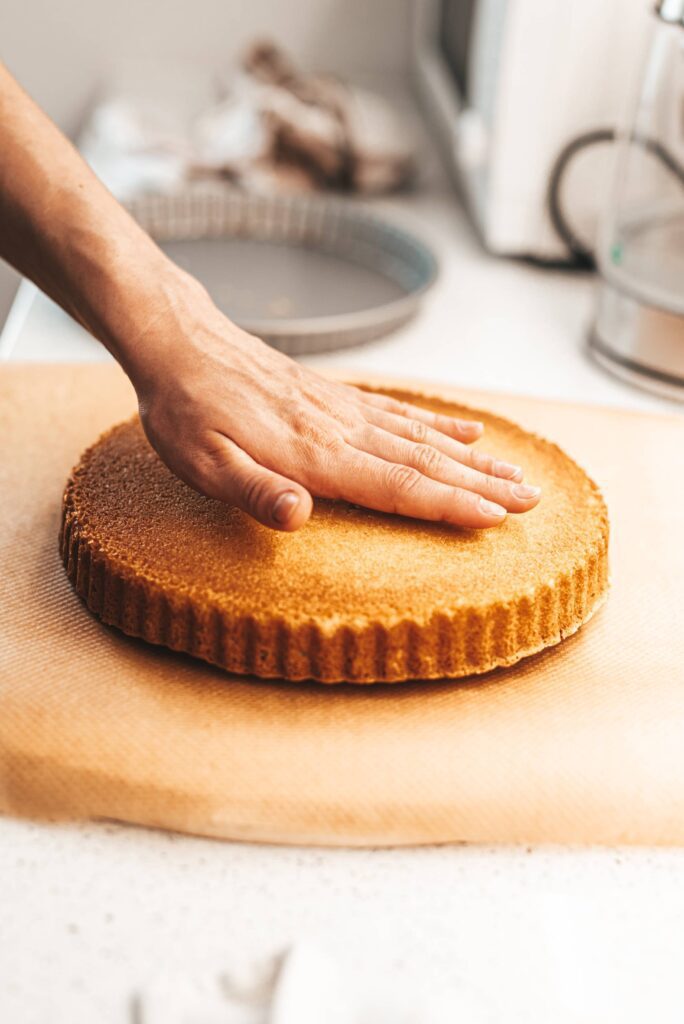 Chef’s Hand Checks The Temperature of The Cake Free Photo