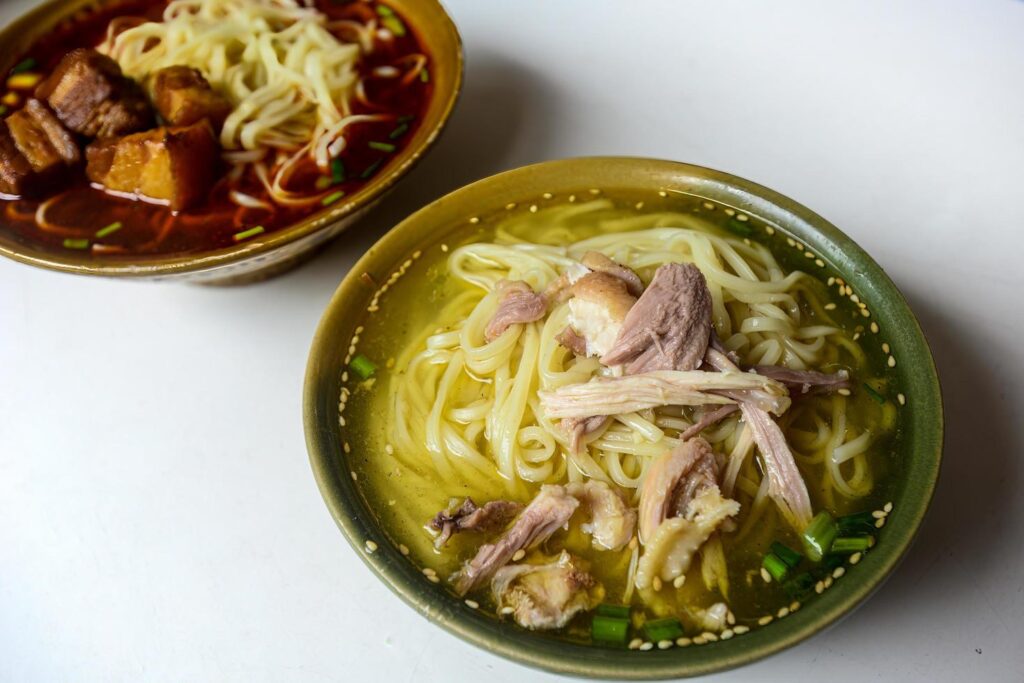 Chicken noodle soup and braised pork noodles are common food in China Stock Free