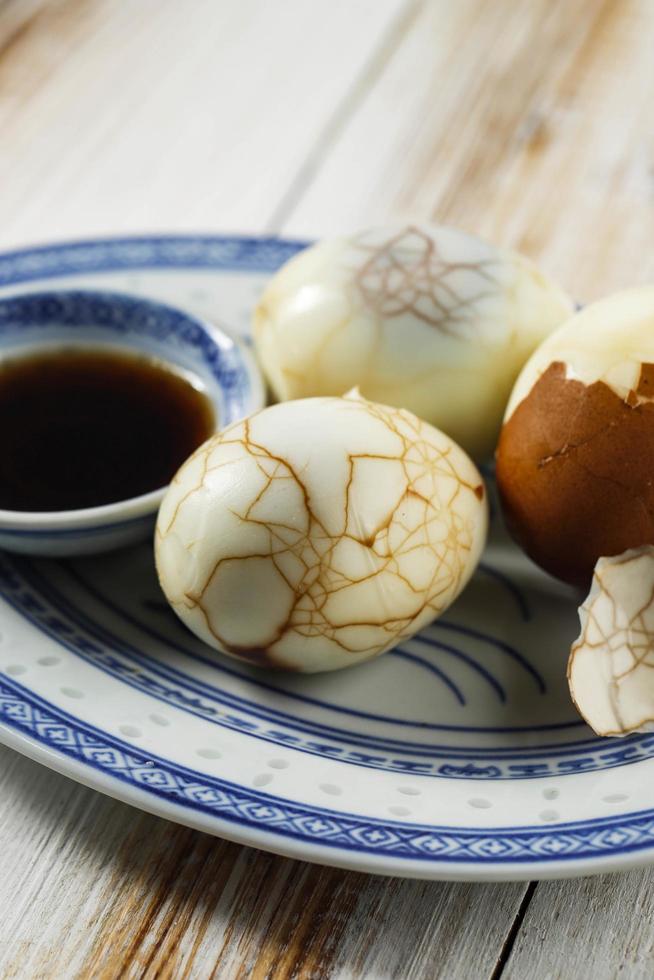 Chinese food boiled marble herbal tea egg on rustic wooden table top. Stock Free