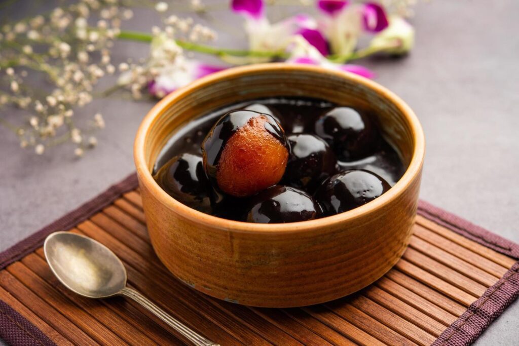 Chocolate dipped gulab jamun, indian creative fusion dessert food Stock Free