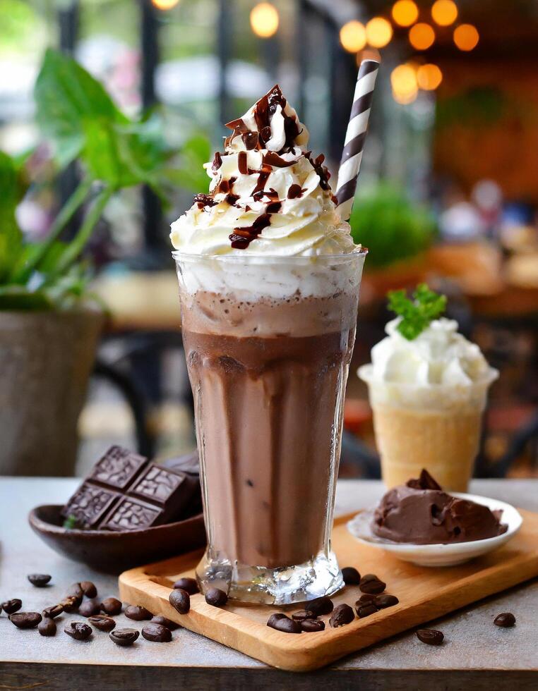 Chocolate milkshake with whipped cream and cafe background Stock Free